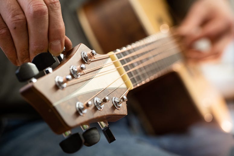 REMAGEN, GERMANY - DECEMBER 11: Master guitar craftsman Tobias Ahlke adjusts the tones on an acoustic guitar body at his workshop on December 11, 2019 in Remagen, Germany. Germany. Ahlke produces acoustic and electric guitars from carefully selected types