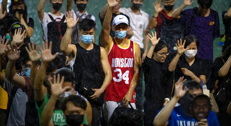 A demonstrator wearing Houston Rockets jersey