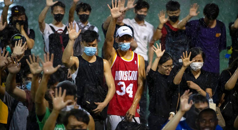 A demonstrator wearing Houston Rockets jersey