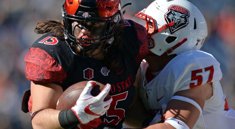 Nov 24, 2017; San Diego, CA, USA; San Diego State Aztecs fullback Nick Bawden (15) is defended by New Mexico Lobos linebacker Everett Powell (57) during the first quarter at SDCCU Stadium.