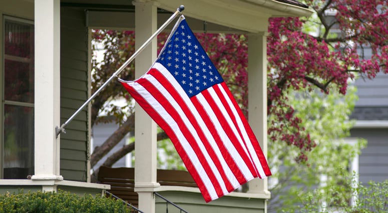 American Flag Hangs Outside a Home - Getty Images American Flag Hangs Outside a Home - Getty Images