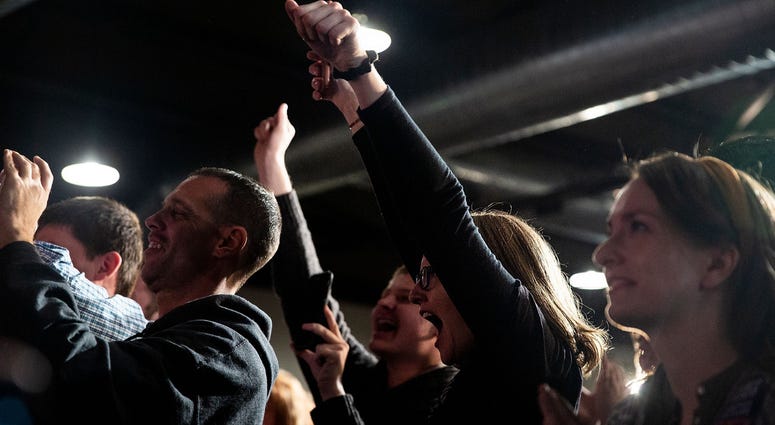 People in the crowd cheer at political rally People in the crowd cheer Elizabeth Warren