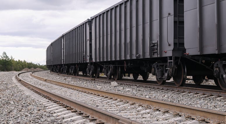 Gray Rail Cars Travel Down Train Tracks - Getty Images Gray Rail Cars Travel Down Train Tracks - Getty Images