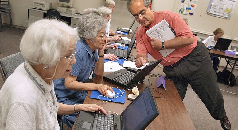 Senior citizens learning computer skills Senior citizens in a classroom