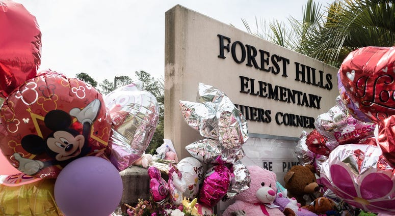 A memorial at the sign of Forest Hills Elementary School in Walterboro, where Raniya Wright, the 5th-grade student died after a fight