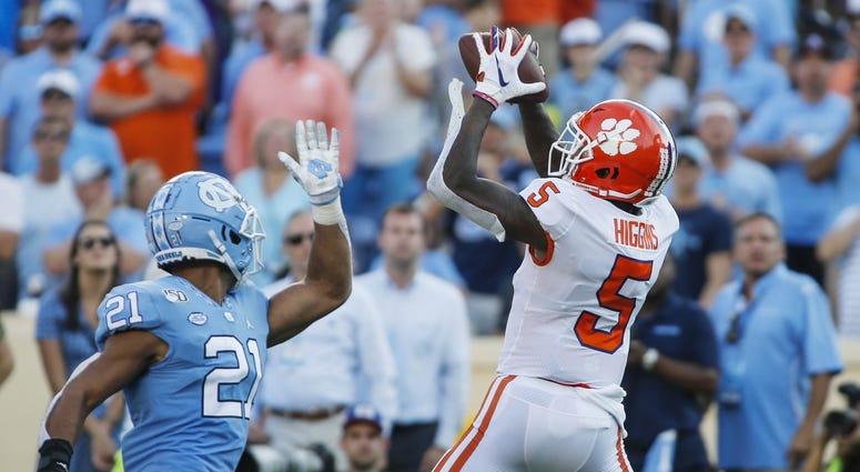 Clemson Tigers wide receiver Tee Higgins (5) catches a pass over North Carolina Tar Heels linebacker Chazz Surratt (21) for a 38-yard touchdown in the second half at Kenan Memorial Stadium.