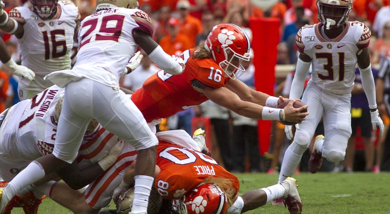 Clemson Tigers quarterback Trevor Lawrence (16) dives for a touchdown during the first quarter of the game against the Florida State Seminoles at Clemson Memorial Stadium.