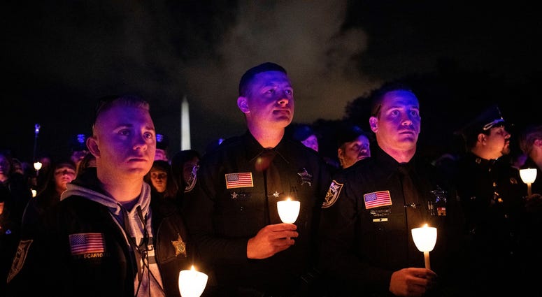 Vigils are being held all over the country to honor fallen officers. Pictured is a vigil held in Washington, DC