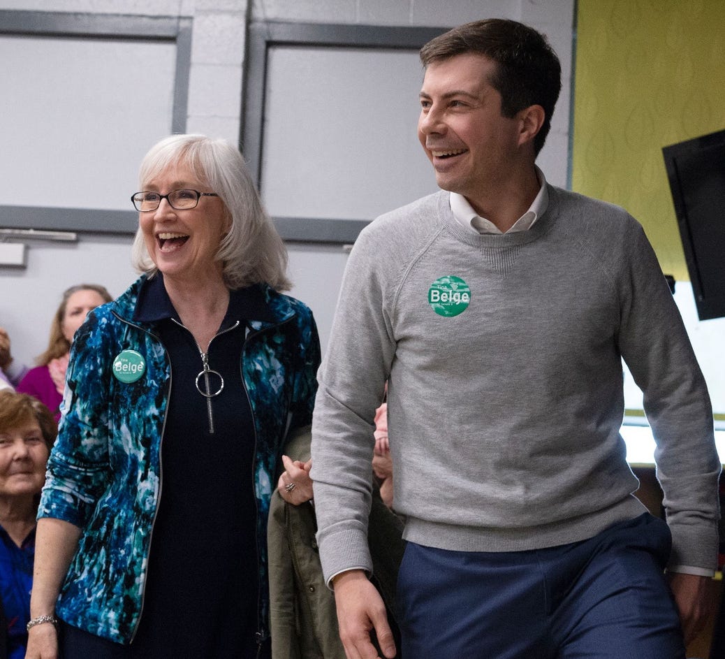 Pete Buttigieg walks with Kate Franch, chair of the Greenville County Democratic Party, Democratic Presidential candidate Pete Buttigieg
