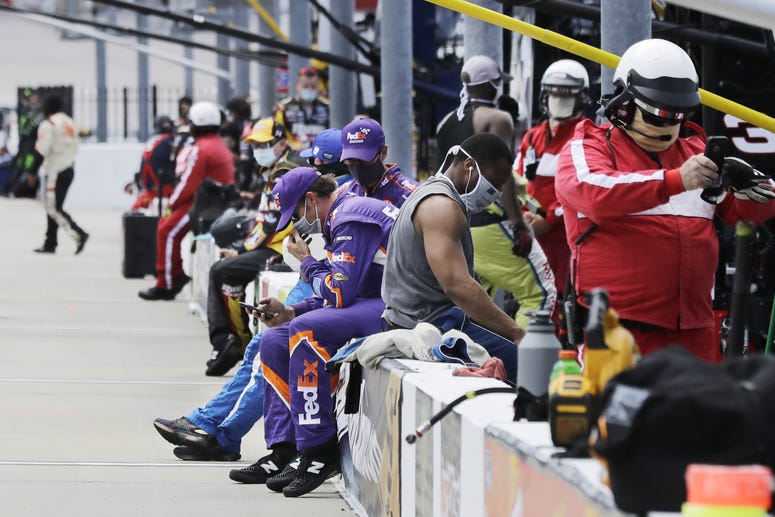 May 17, 2020, Darlington, SC, USA; Crew members and officials wait in the pit area before the start of the NASCAR Cup Series auto race. May 17, 2020, Darlington, SC, USA; Crew members and officials wait in the pit area before the start of the NASCAR Cup Series auto race.