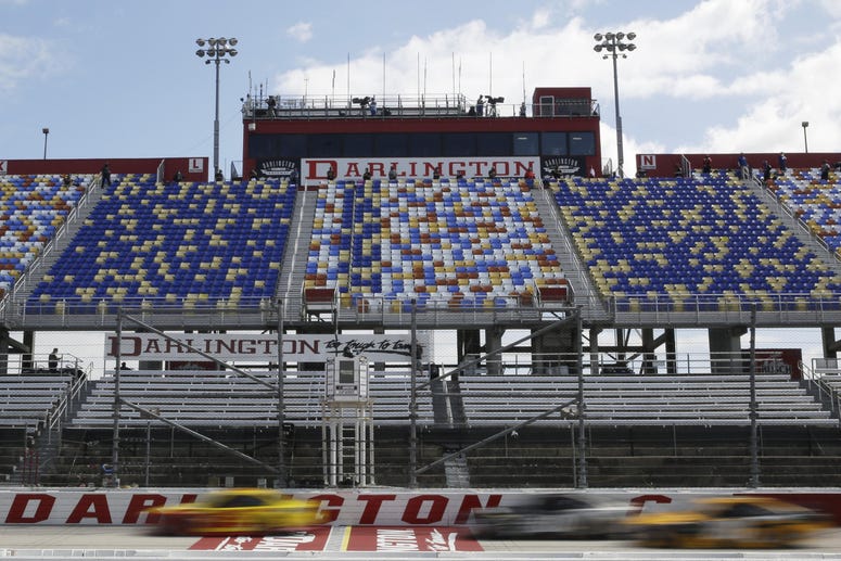 May 17, 2020, Darlington, SC, USA; Cars pass by empty seats during the NASCAR Cup Series auto race. May 17, 2020, Darlington, SC, USA; Cars pass by empty seats during the NASCAR Cup Series auto race.