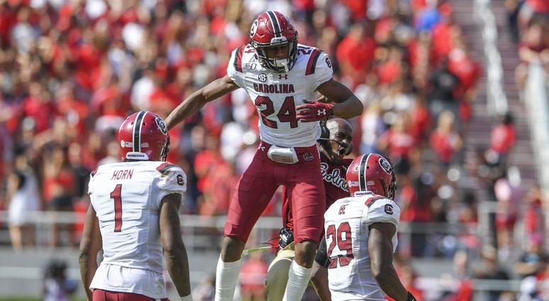 South Carolina Gamecocks defensive back Israel Mukuamu (24) reacts after intercepting a pass against the Georgia Bulldogs during the second half at Sanford Stadium.