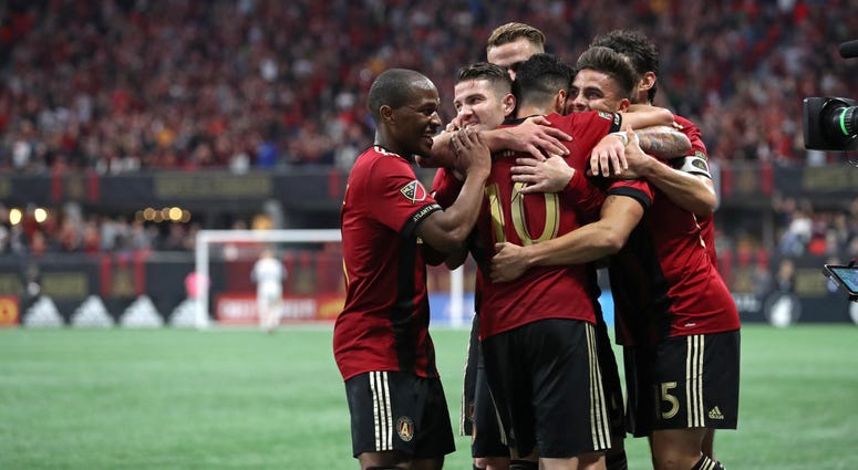 Atlanta United forward Hector Villalba (15, facing right) celebrate with midfielder Darlington Nagbe (6, left), defender Greg Garza (facing left) and midfielder Miguel Almiron (10) after his goal during the second half against D.C. United at Mercedes-Benz