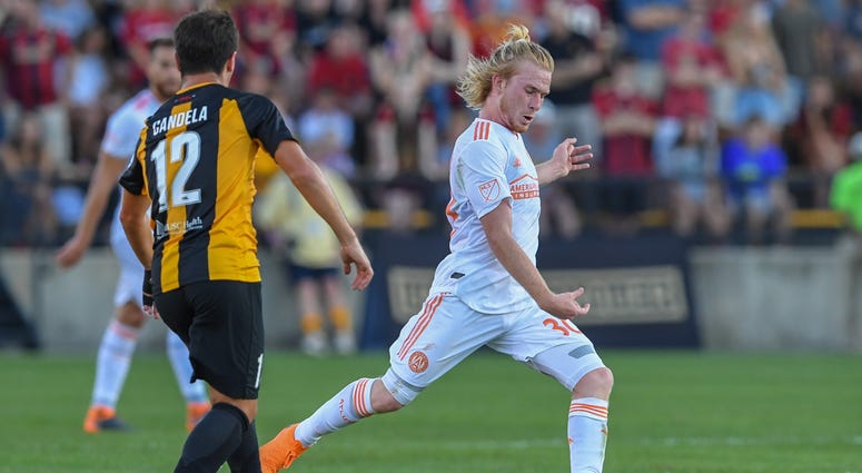 Atlanta United forward Andrew Carleton (30) controls the ball in front of Charleston Battery midfielder Vincenzo Candela (12) during the first half at Fifth Third Bank Stadium.