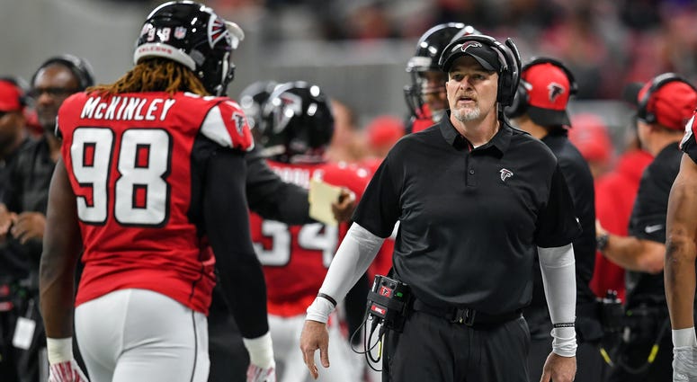Dec 16, 2018; Atlanta, GA, USA; Atlanta Falcons head coach Dan Quinn reacts with defensive end Takkarist McKinley (98) on the sideline against the Arizona Cardinals during the first half at Mercedes-Benz Stadium. Mandatory Credit: Dale Zanine-USA TODAY Sp