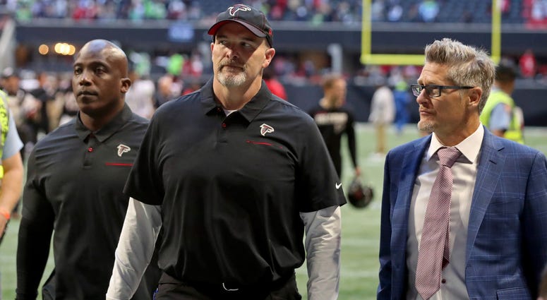 Oct 27, 2019; Atlanta, GA, USA; Atlanta Falcons head coach Dan Quinn (middle) leaves the field with general manager Thomas Dimitroff (right) after a loss to the Seattle Seahawks at Mercedes-Benz Stadium. Mandatory Credit: Jason Getz-USA TODAY Sports