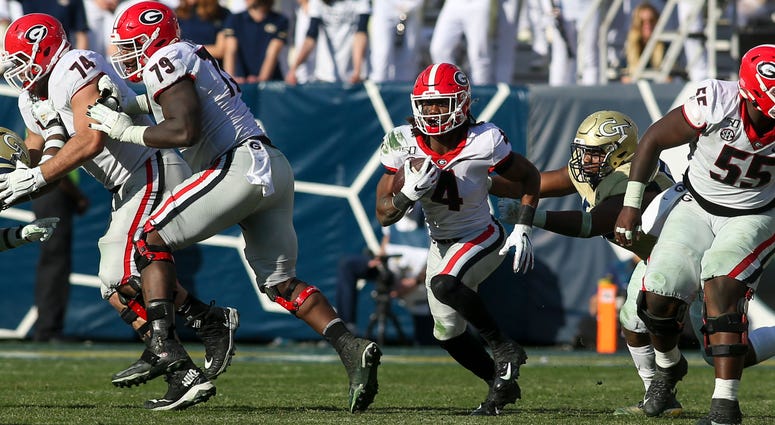 Nov 30, 2019; Atlanta, GA, USA; Georgia Bulldogs running back James Cook (4) runs the ball against the Georgia Tech Yellow Jackets in the second half at Bobby Dodd Stadium. Mandatory Credit: Brett Davis-USA TODAY Sports