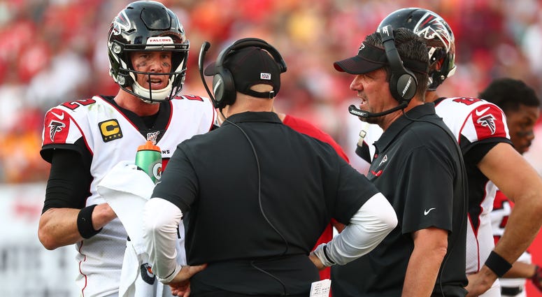 Dec 29, 2019; Tampa, Florida, USA;Atlanta Falcons quarterback Matt Ryan (2) talks with head coach Dan Quinn and quarterback coach Greg Knapp during the second half against the Tampa Bay Buccaneers at Raymond James Stadium. Mandatory Credit: Kim Klement-US
