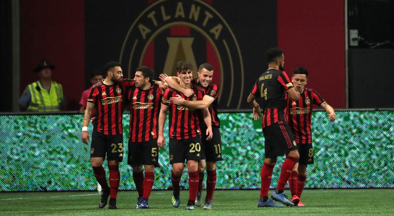 Mar 7, 2020; Atlanta, Georgia, USA; Atlanta United midfielder Emerson Hyndman (20) celebrates his goal with defender Brooks Lennon (11) in the second half against the FC Cincinnati at Mercedes-Benz Stadium. Mandatory Credit: Jason Getz-USA TODAY Sports