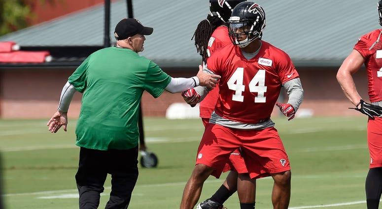 Aug 1, 2015; Atlanta, GA, USA; Atlanta Falcons head coach Dan Quinn works with defensive end Vic Beasley (44) on the field during training camp at the Flowery Branch Training Facility. Mandatory Credit: Dale Zanine-USA TODAY Sports