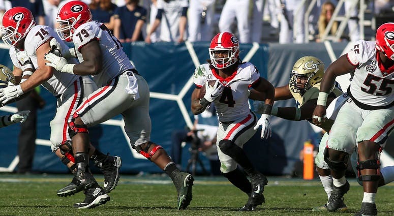 Nov 30, 2019; Atlanta, GA, USA; Georgia Bulldogs running back James Cook (4) runs the ball against the Georgia Tech Yellow Jackets in the second half at Bobby Dodd Stadium. Mandatory Credit: Brett Davis-USA TODAY Sports
