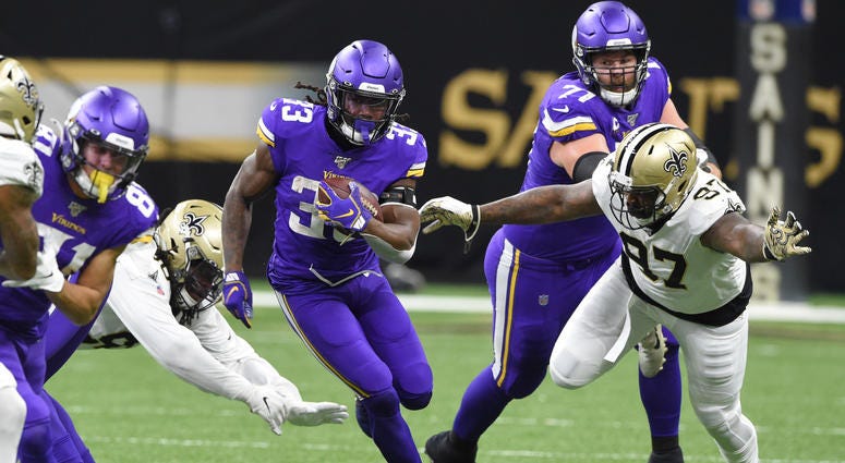 Jan 5, 2020; New Orleans, Louisiana, USA; Minnesota Vikings running back Dalvin Cook (33) runs the ball against New Orleans Saints defensive end Mario Edwards (97) during the first quarter of a NFC Wild Card playoff football game at the Mercedes-Benz Supe
